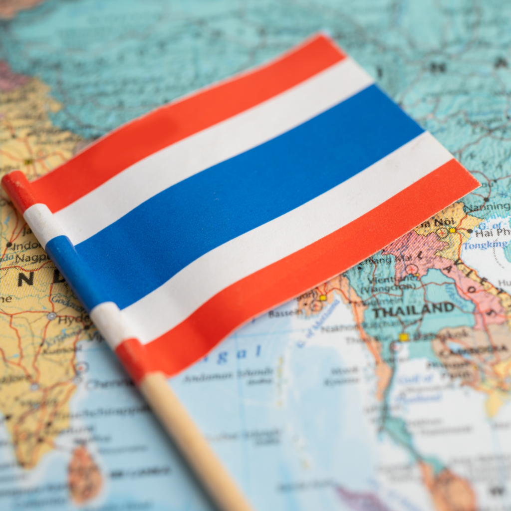 Thai flag standing on a map of Thailand. ธงชาติไทยปักบนแผนที่ประเทศไทย